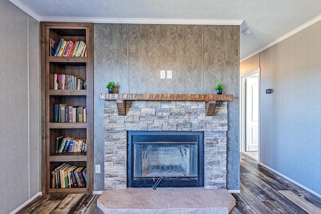 details featuring a textured ceiling, crown molding, built in shelves, and wood finished floors