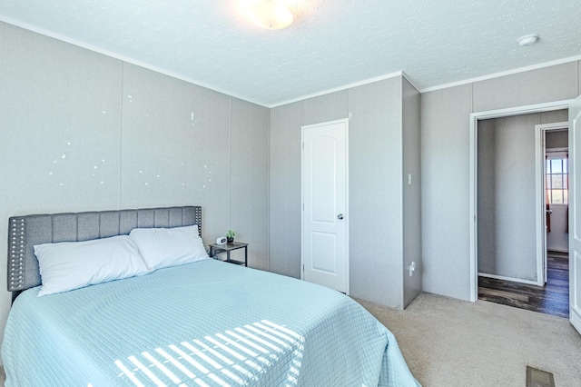 carpeted bedroom with visible vents and a textured ceiling