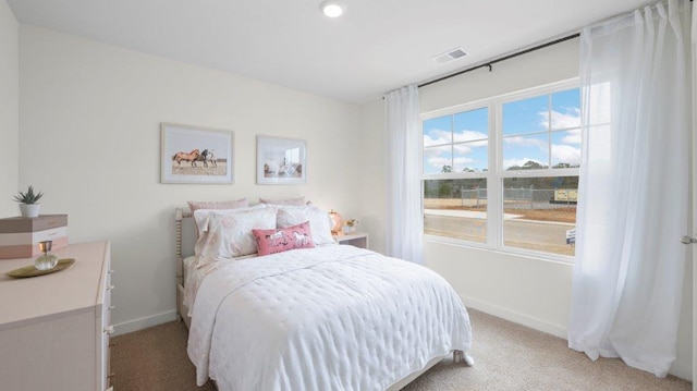 bedroom featuring light carpet, baseboards, and visible vents