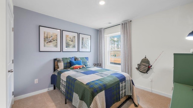 carpeted bedroom with visible vents and baseboards