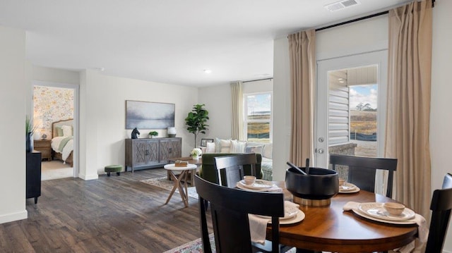 dining space featuring baseboards, visible vents, and dark wood-style flooring