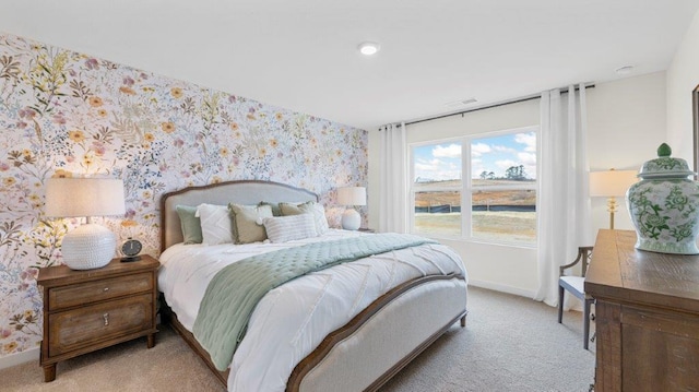 bedroom with baseboards, light colored carpet, and wallpapered walls