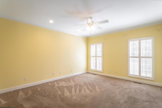 carpeted empty room with visible vents, recessed lighting, crown molding, and baseboards