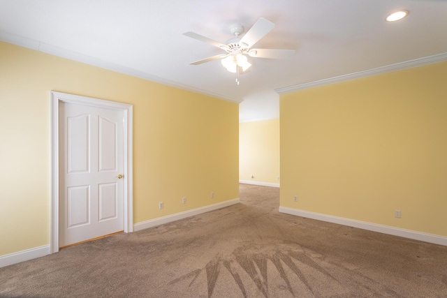 unfurnished room with carpet floors, ceiling fan, baseboards, and ornamental molding