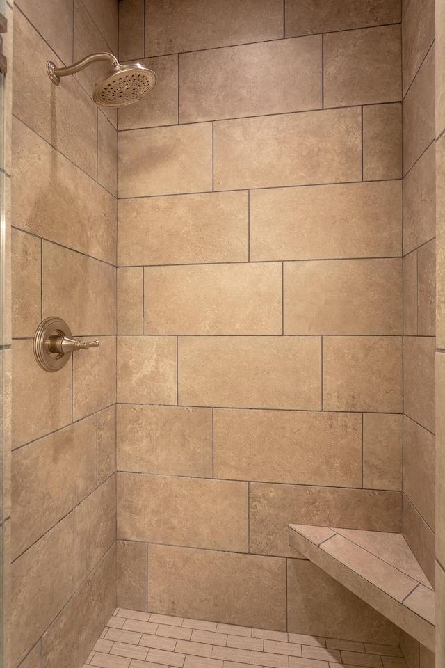 full bath featuring tiled shower