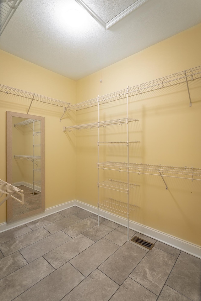 spacious closet with visible vents and attic access