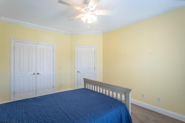 unfurnished bedroom featuring baseboards, ceiling fan, ornamental molding, a closet, and carpet flooring