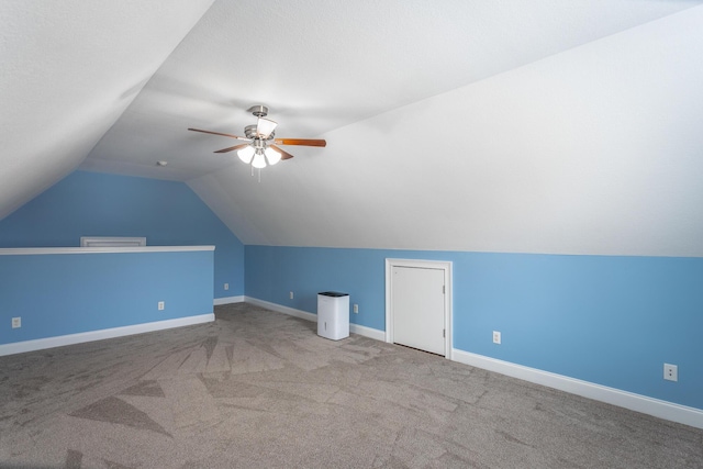 additional living space featuring baseboards, ceiling fan, carpet flooring, and vaulted ceiling