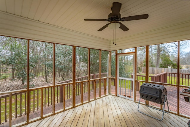 unfurnished sunroom featuring a ceiling fan