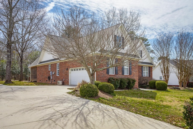 view of home's exterior with driveway, brick siding, an attached garage, and a lawn