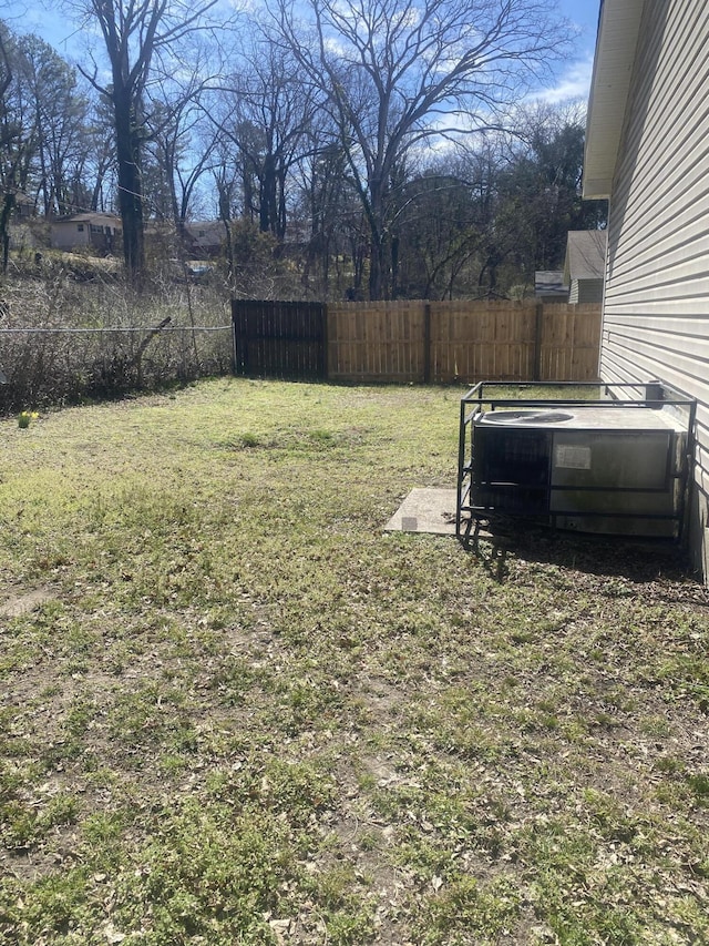 view of yard featuring cooling unit and fence