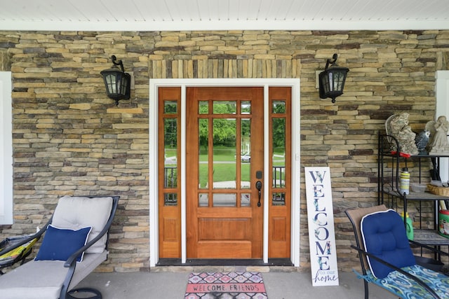 property entrance featuring stone siding