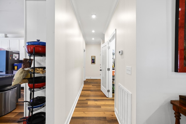 hall with crown molding, recessed lighting, visible vents, wood finished floors, and baseboards