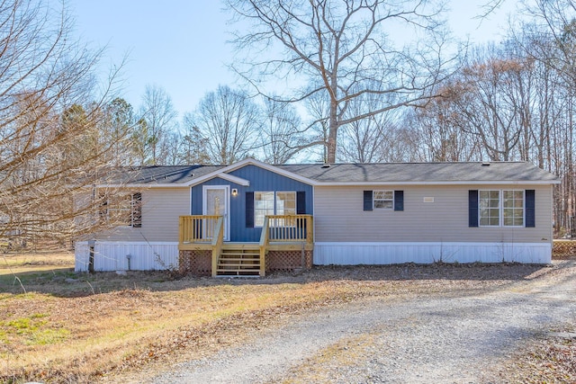 manufactured / mobile home with a deck and driveway