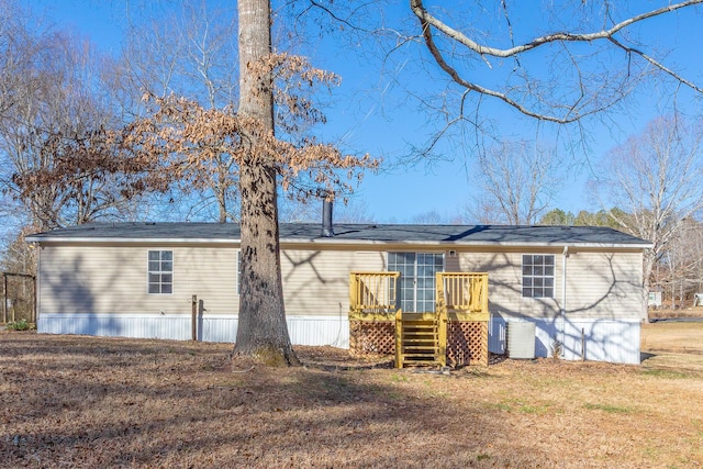 back of house featuring stairs, a yard, and a wooden deck