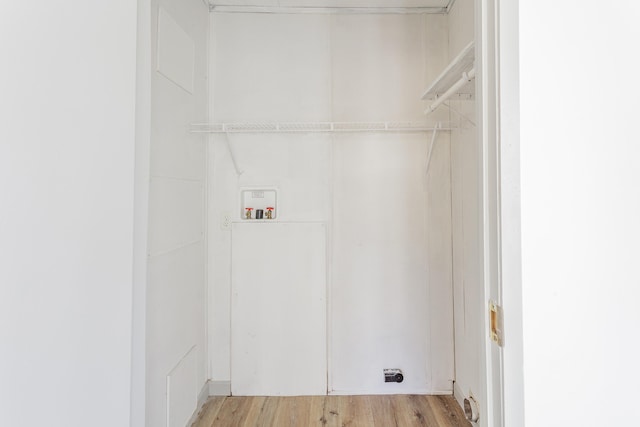 laundry room with washer hookup, laundry area, and light wood finished floors