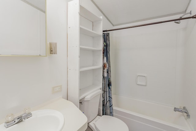 bathroom featuring shower / bath combo with shower curtain, a sink, and toilet