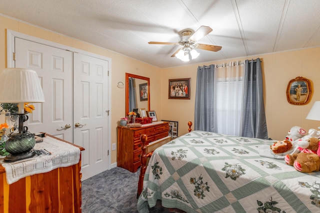 bedroom with a ceiling fan, a closet, and dark carpet