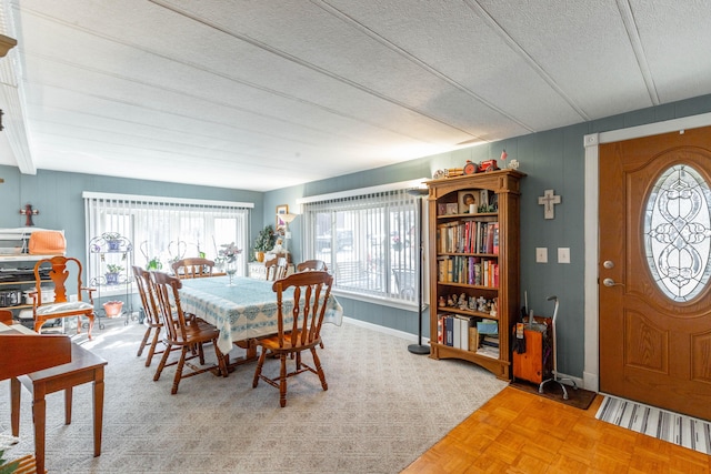 dining area featuring baseboards and a textured ceiling