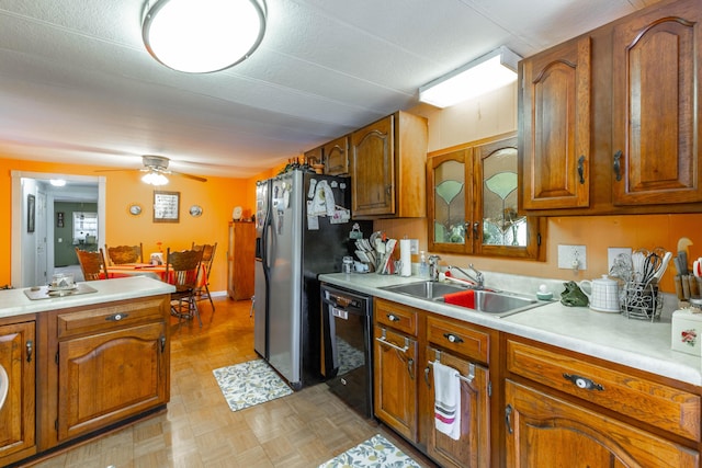 kitchen featuring a sink, black dishwasher, light countertops, stainless steel refrigerator with ice dispenser, and brown cabinets