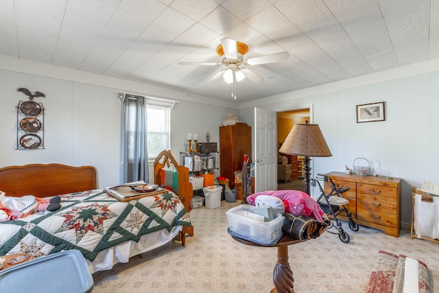 bedroom featuring ceiling fan and carpet