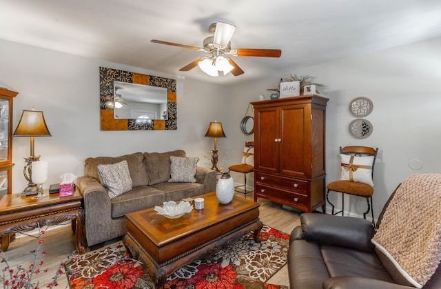 living area featuring a ceiling fan and light wood-style floors