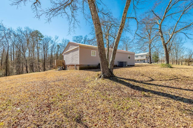 view of side of property featuring central AC