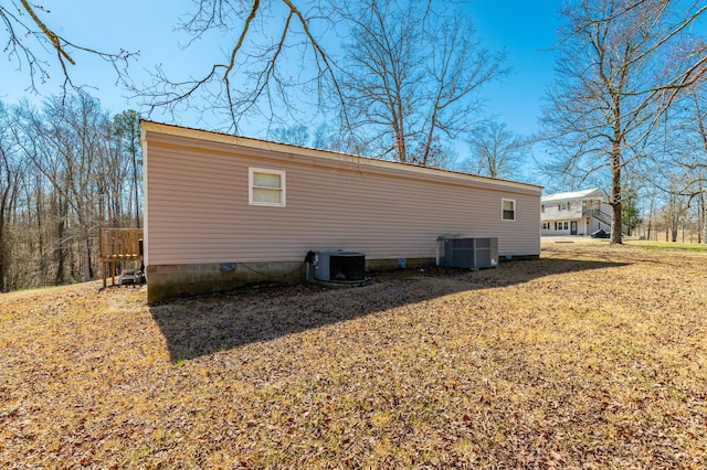 view of side of home with central AC unit