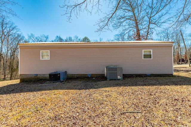 view of side of property with metal roof and central AC