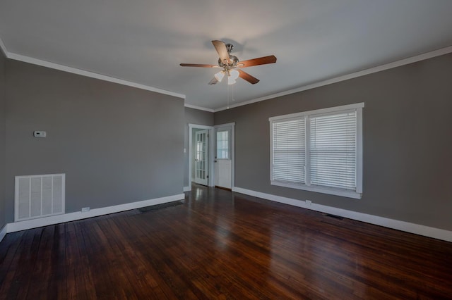 unfurnished room with dark wood-style floors, ornamental molding, visible vents, and baseboards