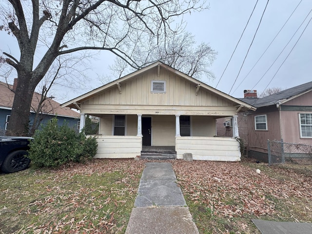 bungalow with covered porch and fence