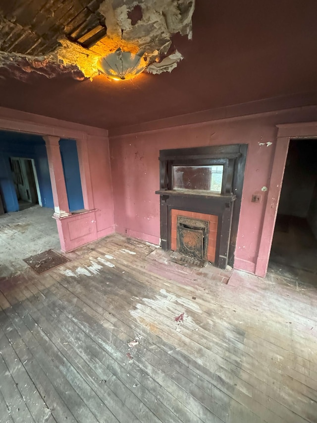 unfurnished living room with hardwood / wood-style flooring and a fireplace