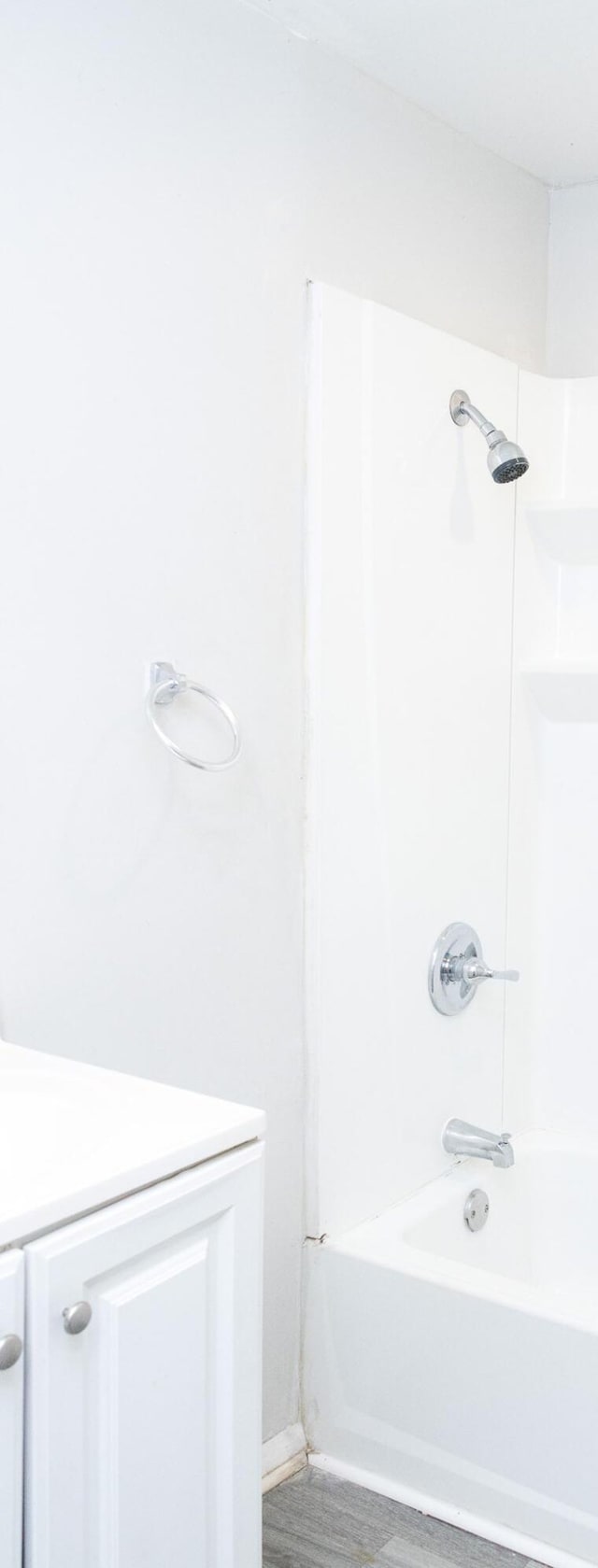 bathroom featuring shower / bath combination and wood finished floors