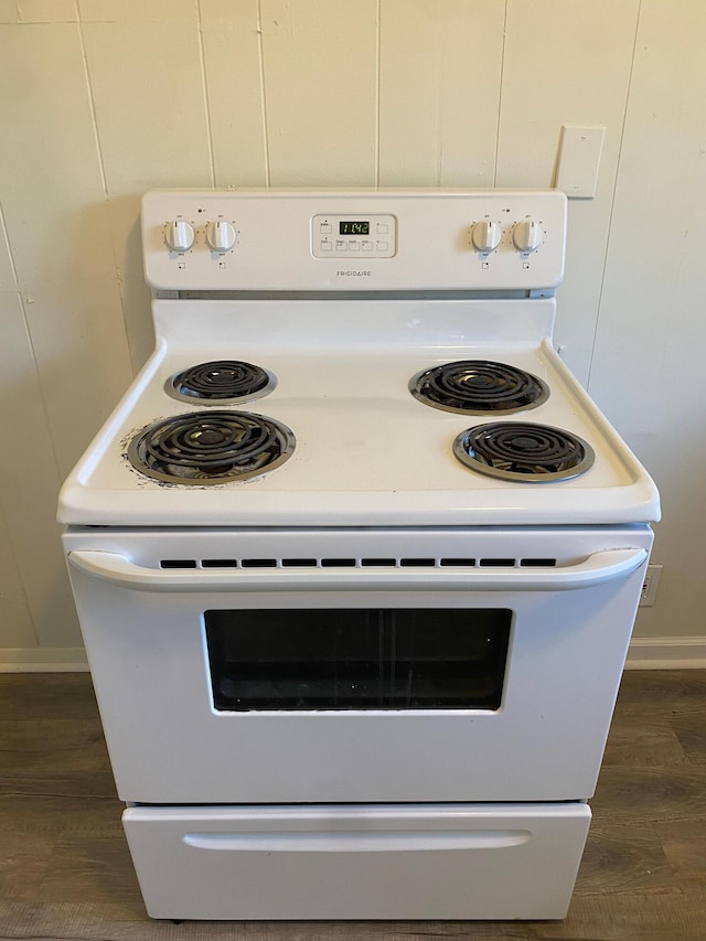 interior details with white range with electric stovetop and dark wood-type flooring