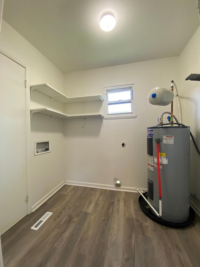 laundry room with laundry area, dark wood-type flooring, hookup for an electric dryer, water heater, and washer hookup