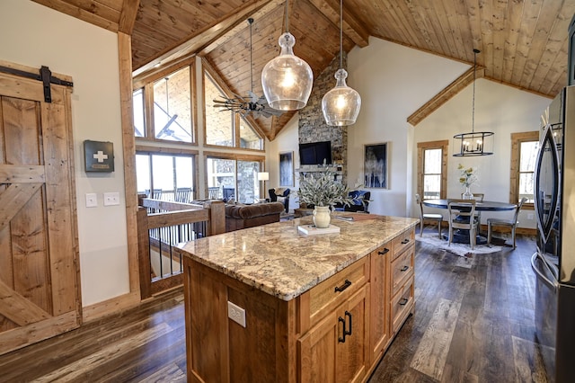 kitchen with wood ceiling, a barn door, dark wood-style flooring, and freestanding refrigerator