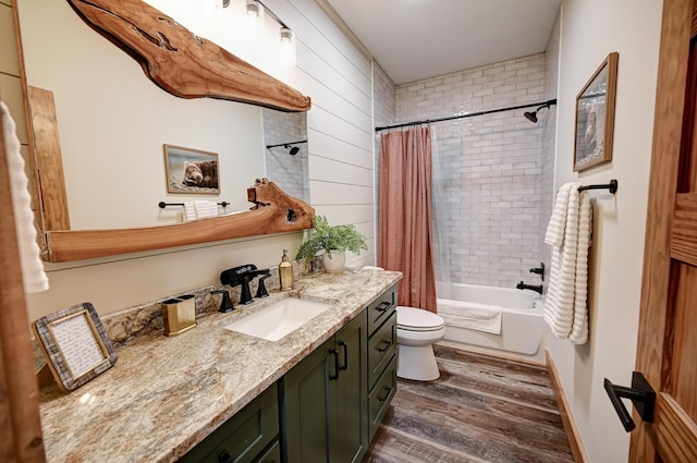 full bath featuring toilet, shower / bath combo with shower curtain, wood finished floors, and vanity