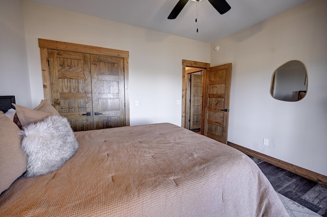 bedroom with wood finished floors, a ceiling fan, and baseboards