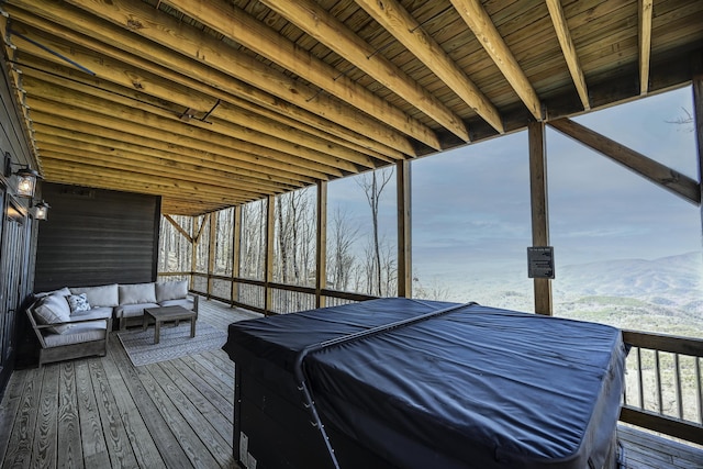 wooden deck with outdoor lounge area and a mountain view