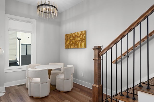 dining space with visible vents, stairs, baseboards, and wood finished floors