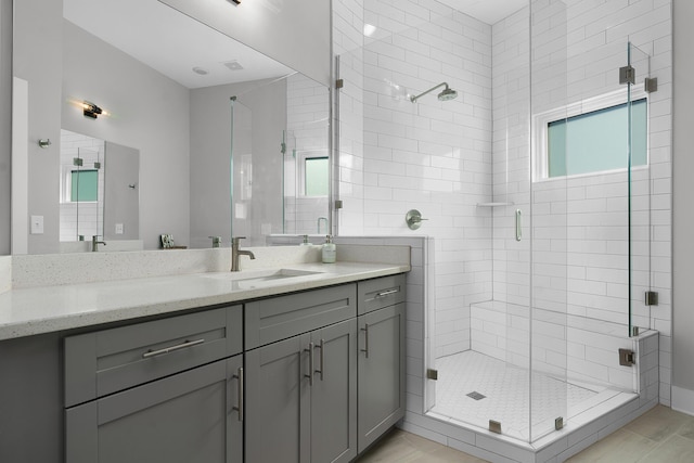 bathroom with a stall shower and vanity