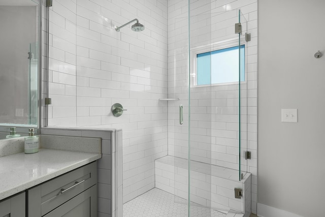 bathroom featuring a shower stall and vanity