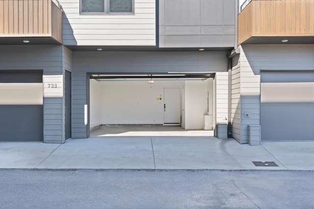 garage featuring concrete driveway