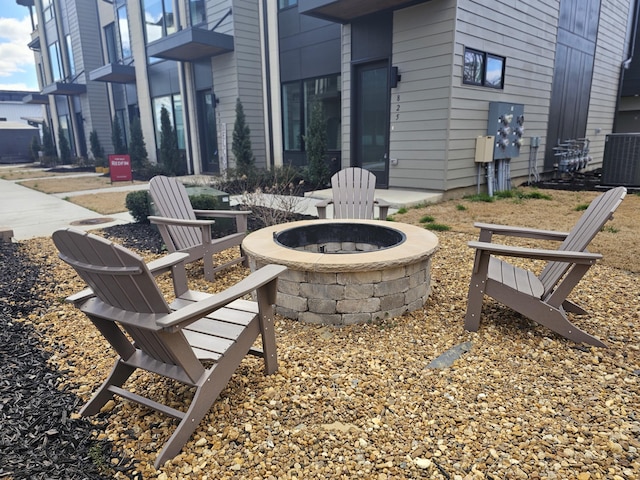 view of patio with a fire pit and central AC unit