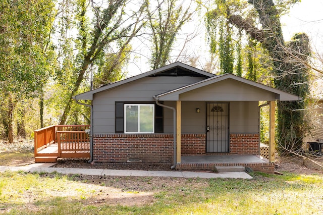 view of front of home with covered porch and brick siding