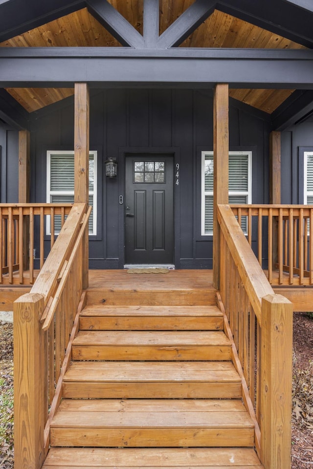 doorway to property with a porch and board and batten siding