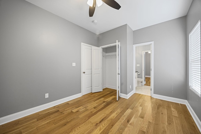 unfurnished bedroom with a closet, baseboards, light wood finished floors, and ceiling fan