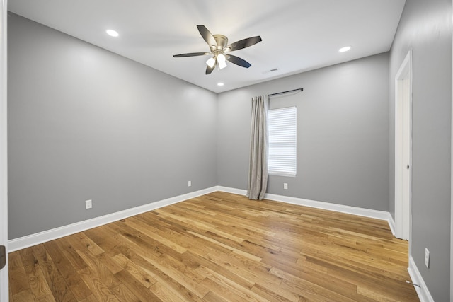 spare room with baseboards, recessed lighting, a ceiling fan, and light wood-style floors