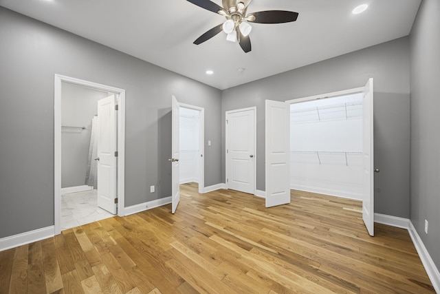 unfurnished bedroom with ensuite bath, recessed lighting, baseboards, and light wood finished floors