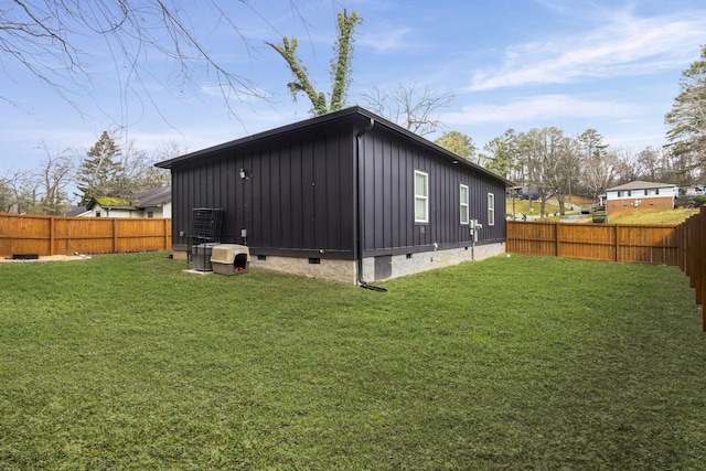 exterior space with crawl space, a yard, board and batten siding, and a fenced backyard